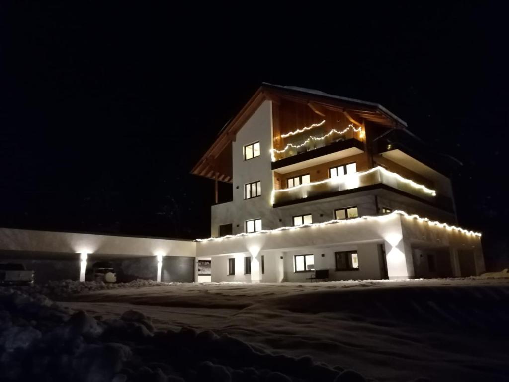 a large building with lights on it at night at Sprungschanze Haus in Murau