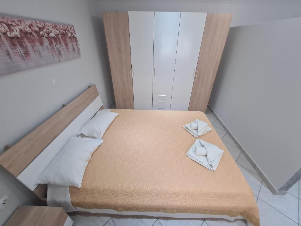 a bedroom with a bed with two white pillows at Villa Valeria Thassos in Limenas