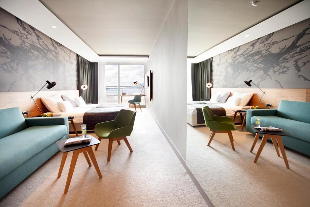 a hotel room with a couch and a bed at Hotel Dubrovnik Palace in Dubrovnik