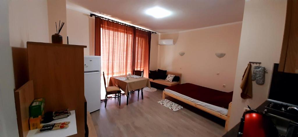 a small room with a bed and a table at На море в Сарафово in Burgas City