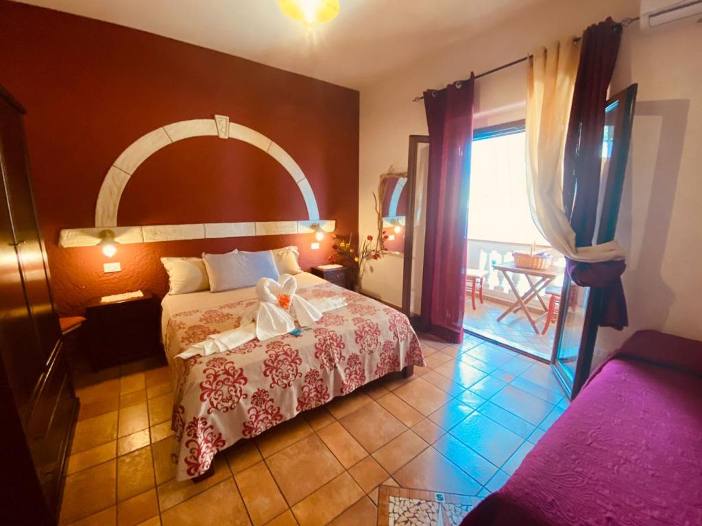 a bedroom with a bed and a large window at Rosa dei Venti Accomodation in Tropea