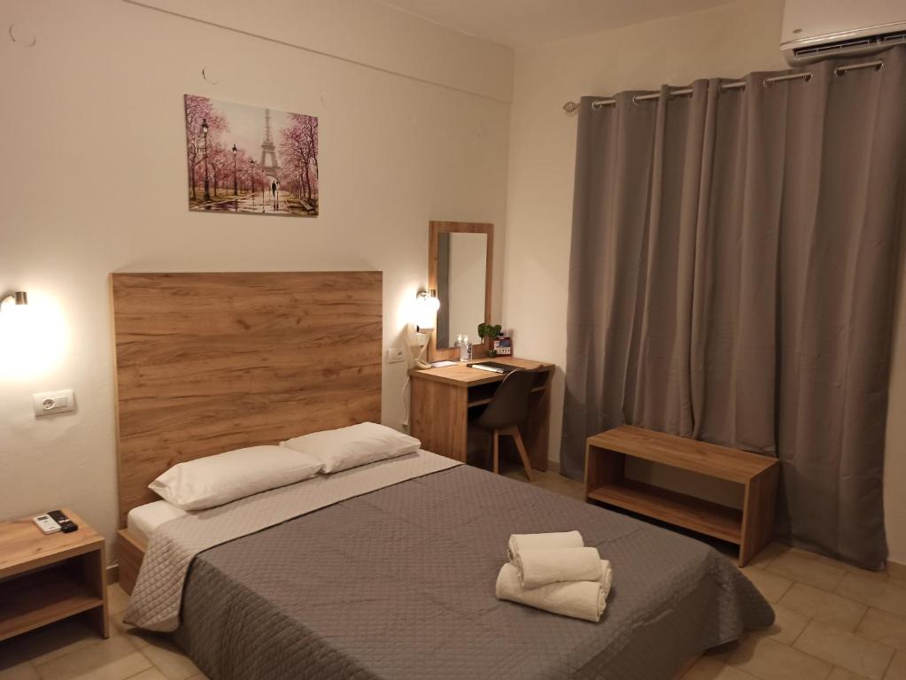 a bedroom with a bed and a desk in it at Summer Desire in Kavos