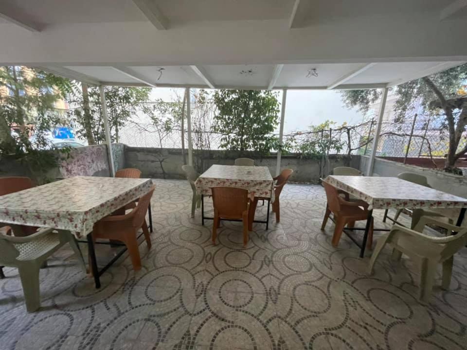 an outdoor patio with tables and chairs at Özgür Hotel in Antalya