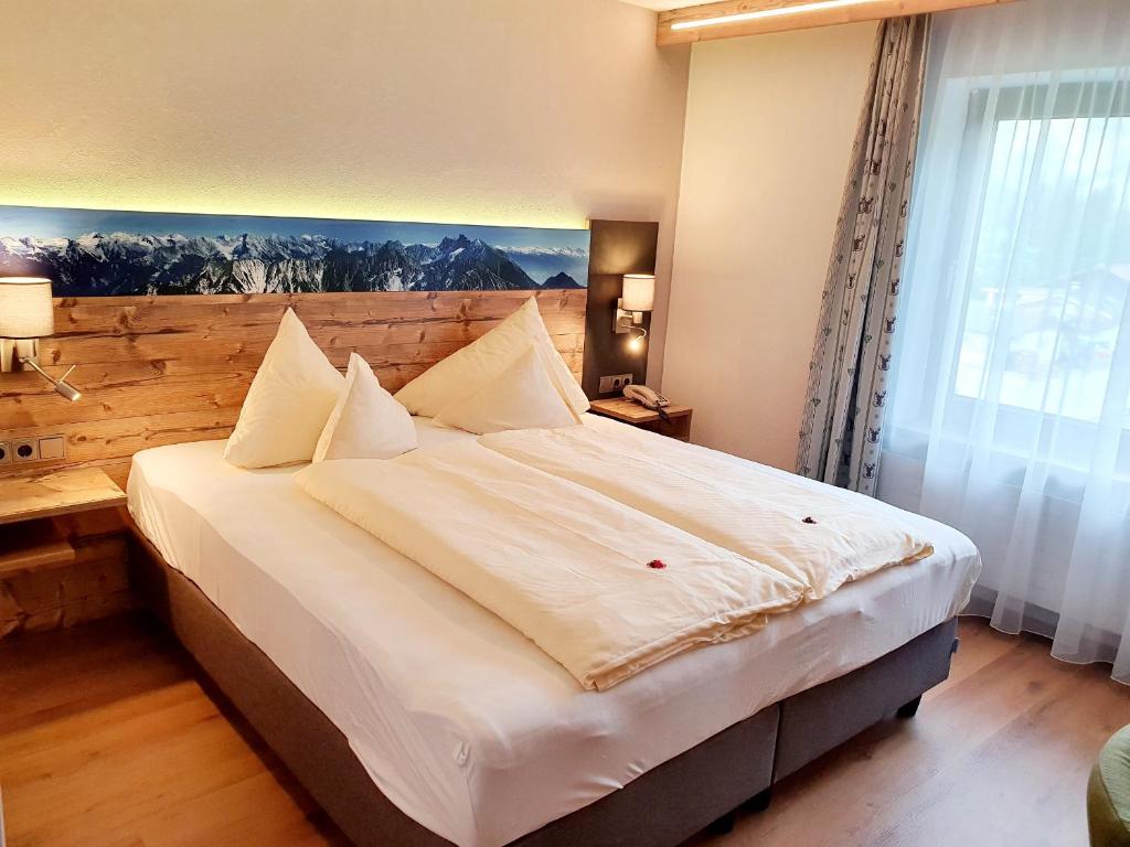 Postel nebo postele na pokoji v ubytování Raffl's Hotel