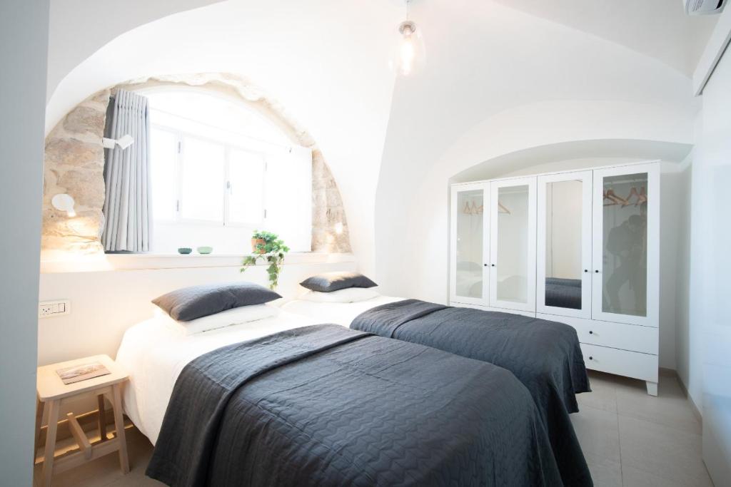 a bedroom with two beds and a window at חקל תפוחין in Safed