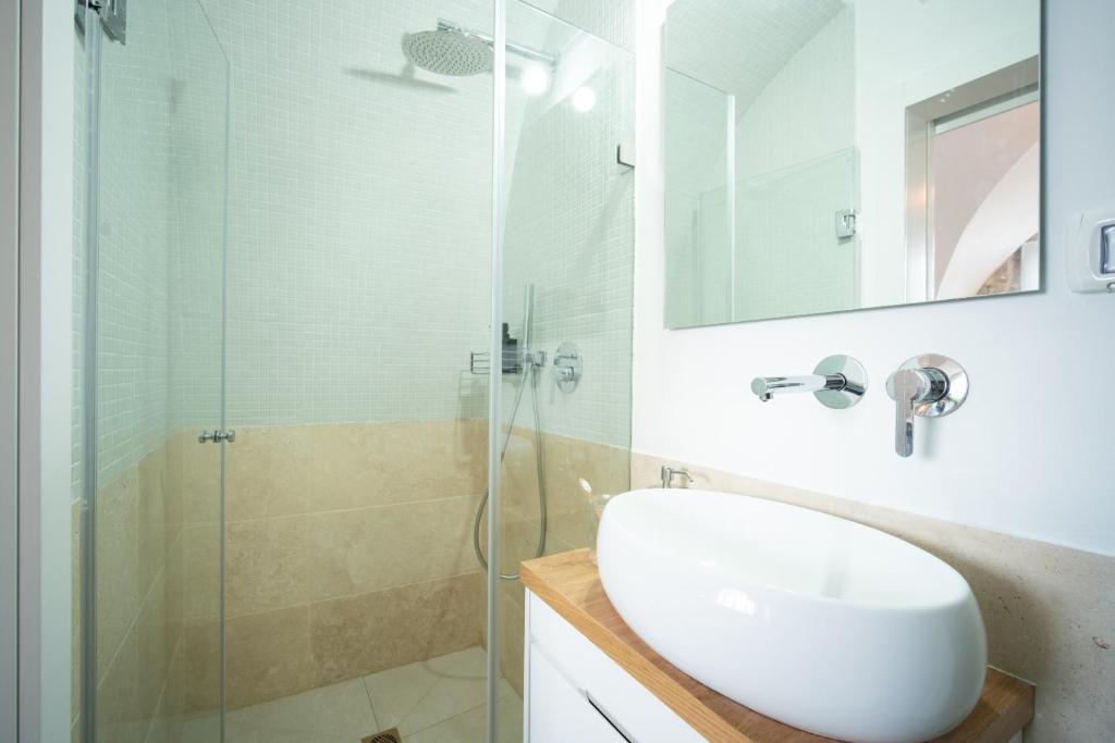a bathroom with a sink and a glass shower at חקל תפוחין in Safed