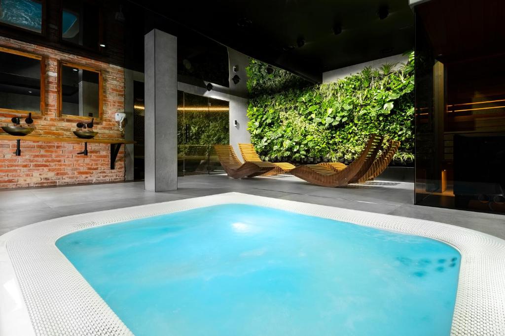 a swimming pool on a patio with a garden at Green Deer Premium in Zakopane