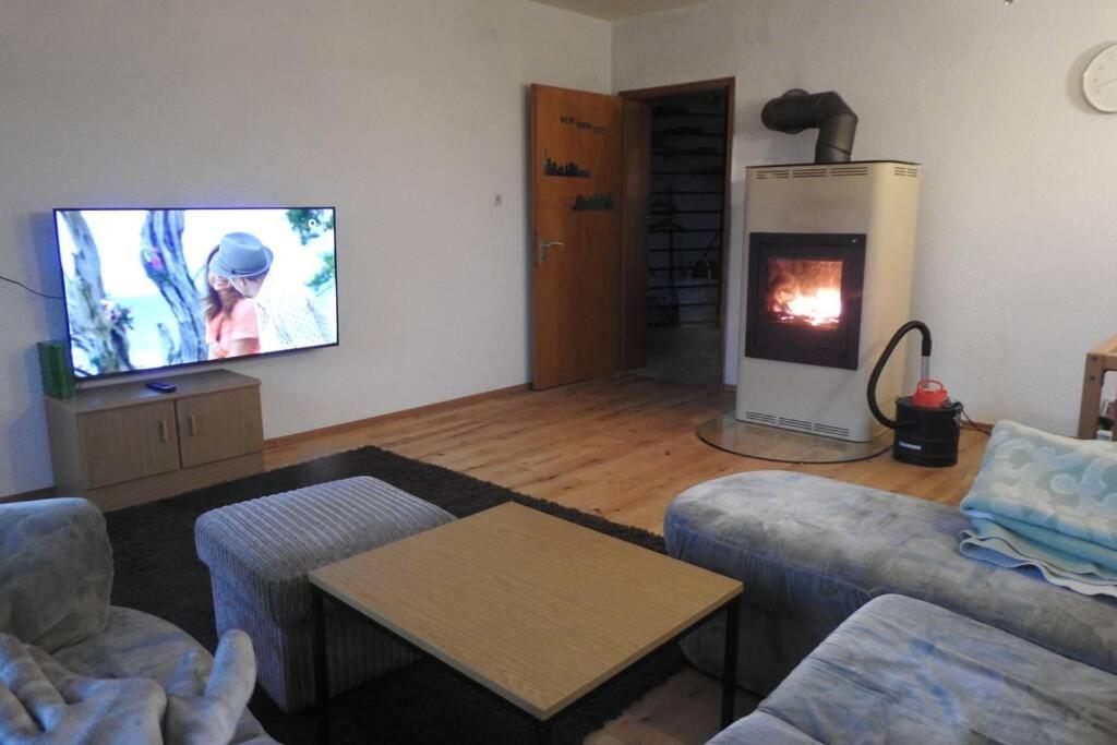 a living room with a couch and a fire place at Bergblick in Medebach