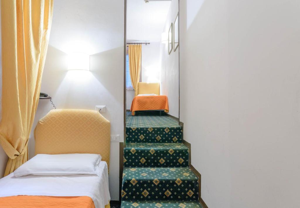 Postel nebo postele na pokoji v ubytování Hotel Rex