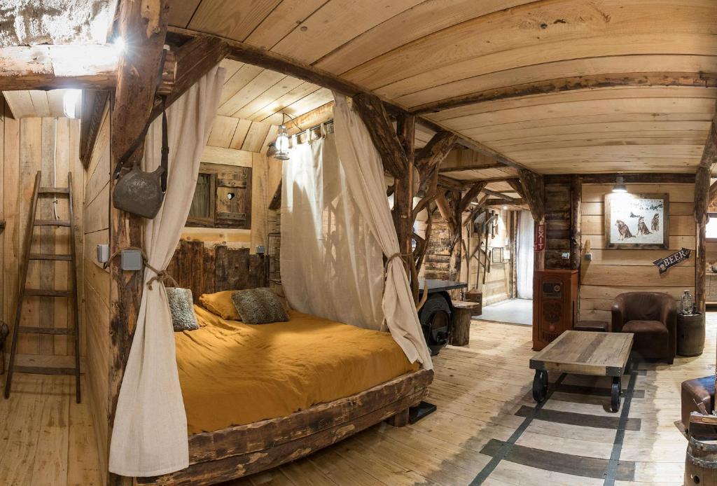 a bedroom in a tree house with a bed in it at La mine de Buck in Le Biot