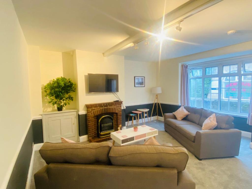 a living room with a couch and a fireplace at Ravelstone in Church Stretton