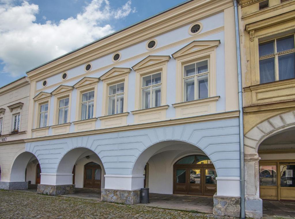 a large building with arches on the side of it at Hotel Anno in Nové Město nad Metují