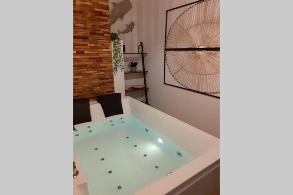 a bathroom with a bath tub in a room at LOVE ROOM OUT OF TIME *JACUZZI* in Itteville