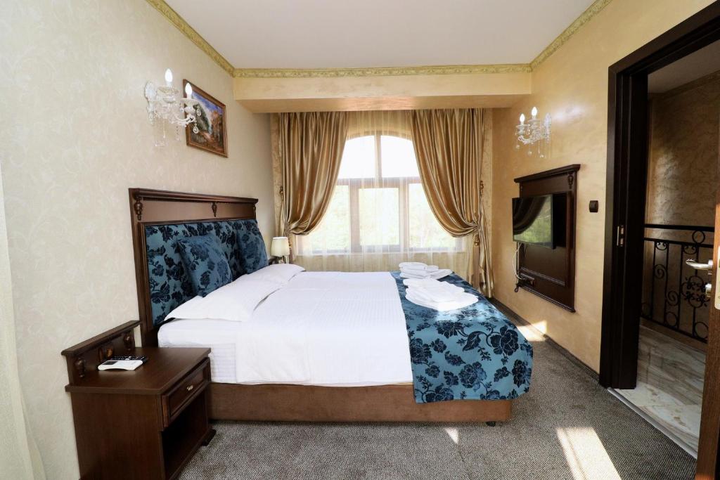 Postel nebo postele na pokoji v ubytování aSa Boutique Hotel