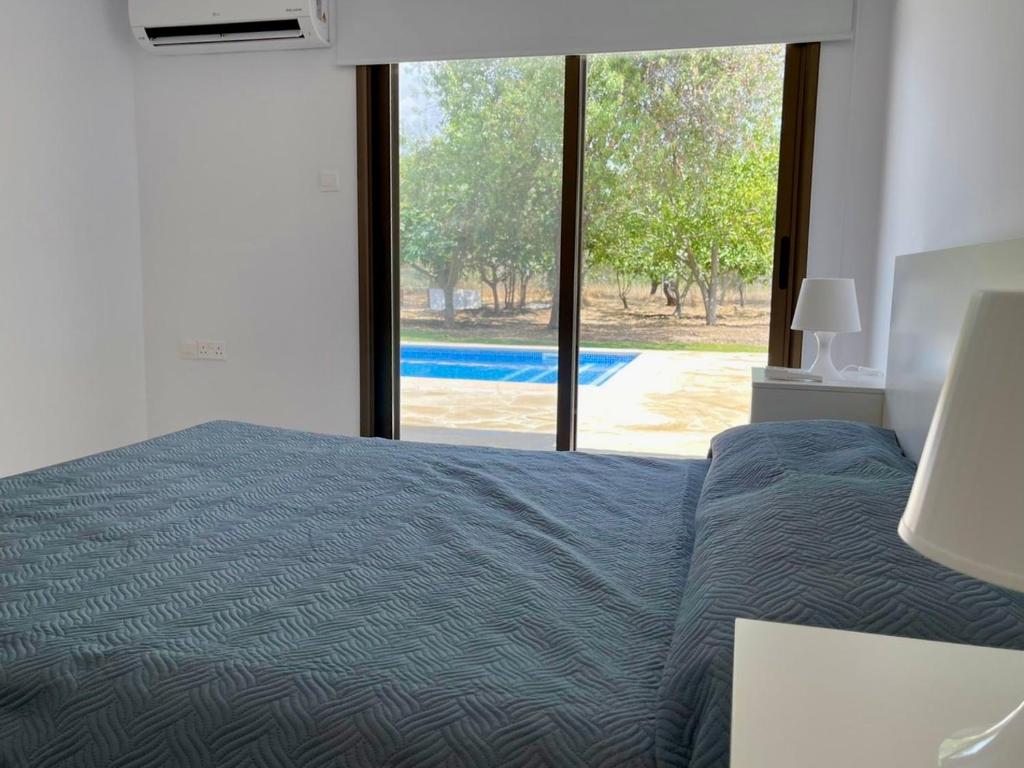 Postel nebo postele na pokoji v ubytování Villa Athasia