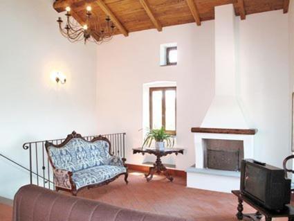 a living room with a couch and a fireplace at Agriturismo La Villa in Bolano