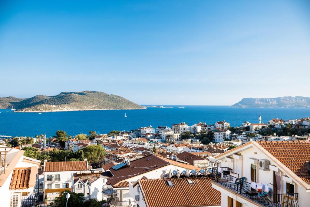 a view of a city with the ocean and houses at Sole Suites in Kas