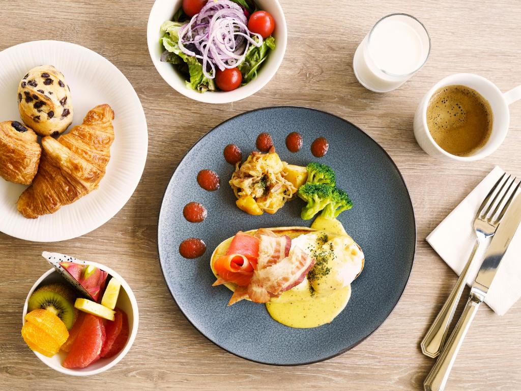 a table with a plate of food on a table at MB GALLERY CHATAN by THE TERRACE HOTELS in Chatan