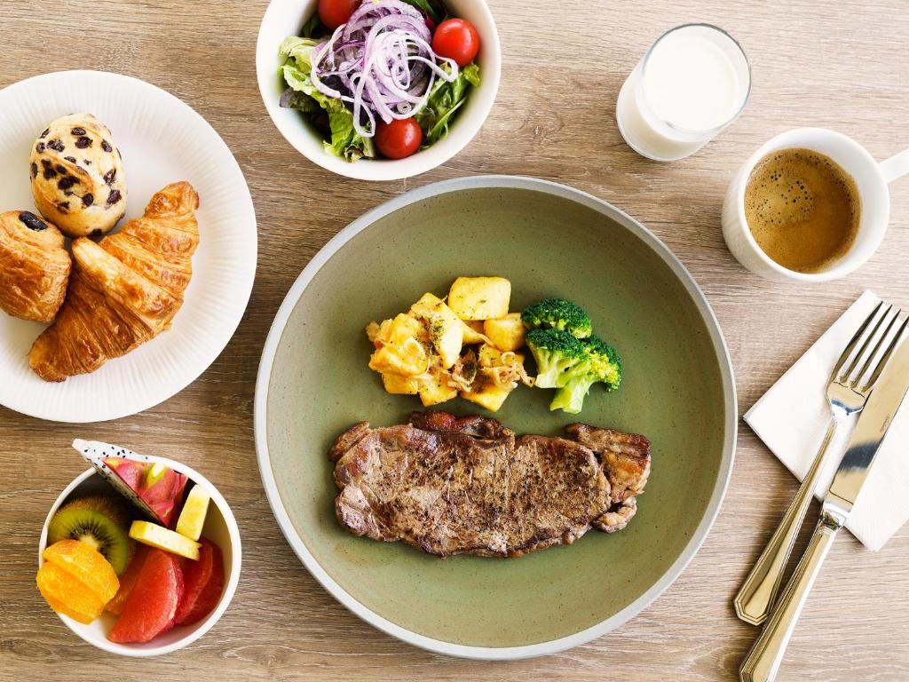 a table with a bowl of food and a plate of food at MB GALLERY CHATAN by THE TERRACE HOTELS in Chatan