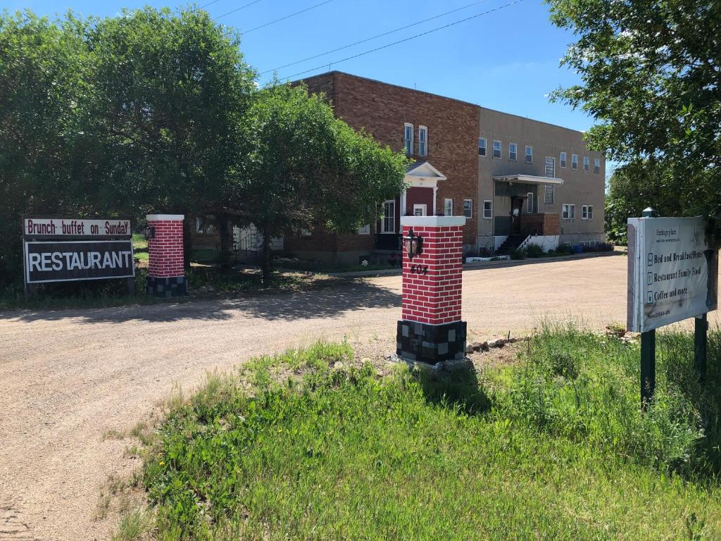 a brick pillar sitting in the middle of a dirt road at Heritage Place Hotel in Gravelbourg