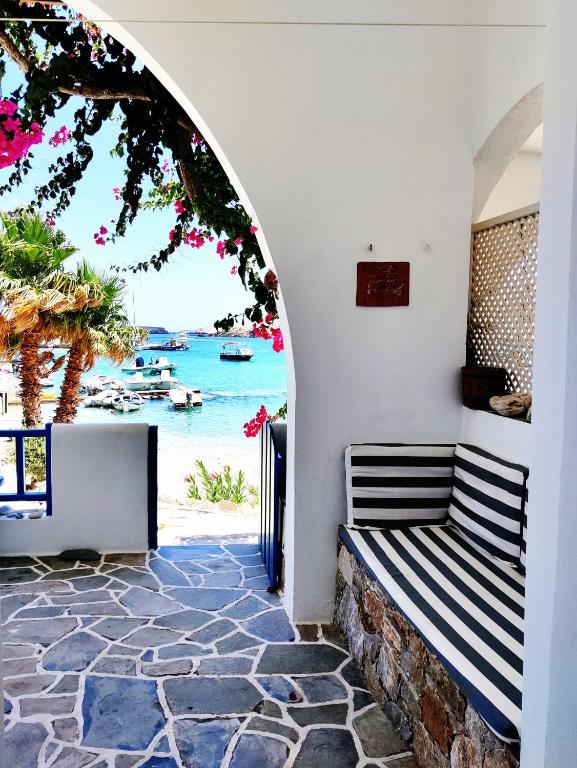 a bench in a room with a view of the beach at Family house by the seaside of Karavostasis in Karavostasi