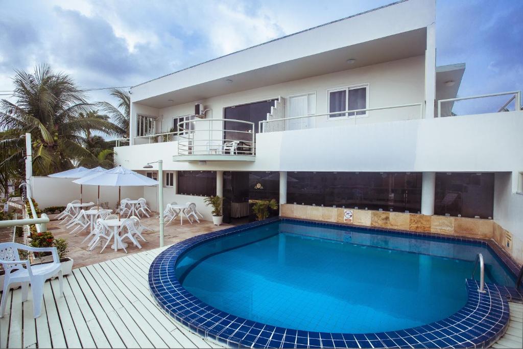 a swimming pool in front of a house at Hotel Belo Horizonte in Natal