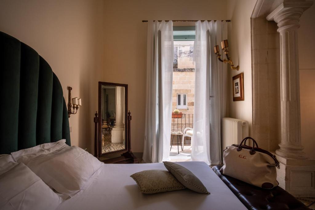 Postel nebo postele na pokoji v ubytování Palazzo Guido