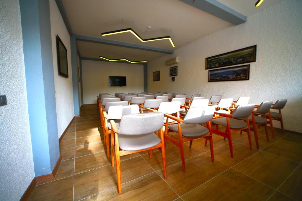 A television and/or entertainment centre at Ölüdeniz Turquoise Hotel - All Inclusive