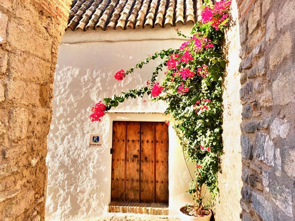 budynek z drzwiami z kwiatami w obiekcie HEAVEN PUERTA CERRADA Casas Vejer Debra w mieście Vejer de la Frontera