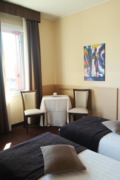 Postel nebo postele na pokoji v ubytování Hotel Vittoria