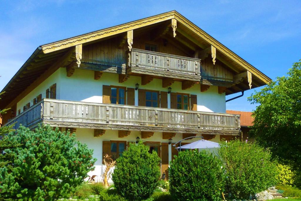 a large house with a balcony on top of it at Ferienwohnungen Maurer Höhenberg in Aschau im Chiemgau