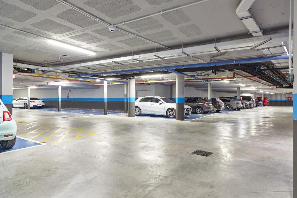 a parking garage with several cars parked in it at Hotel Torre del Mar - Ibiza in Playa d'en Bossa