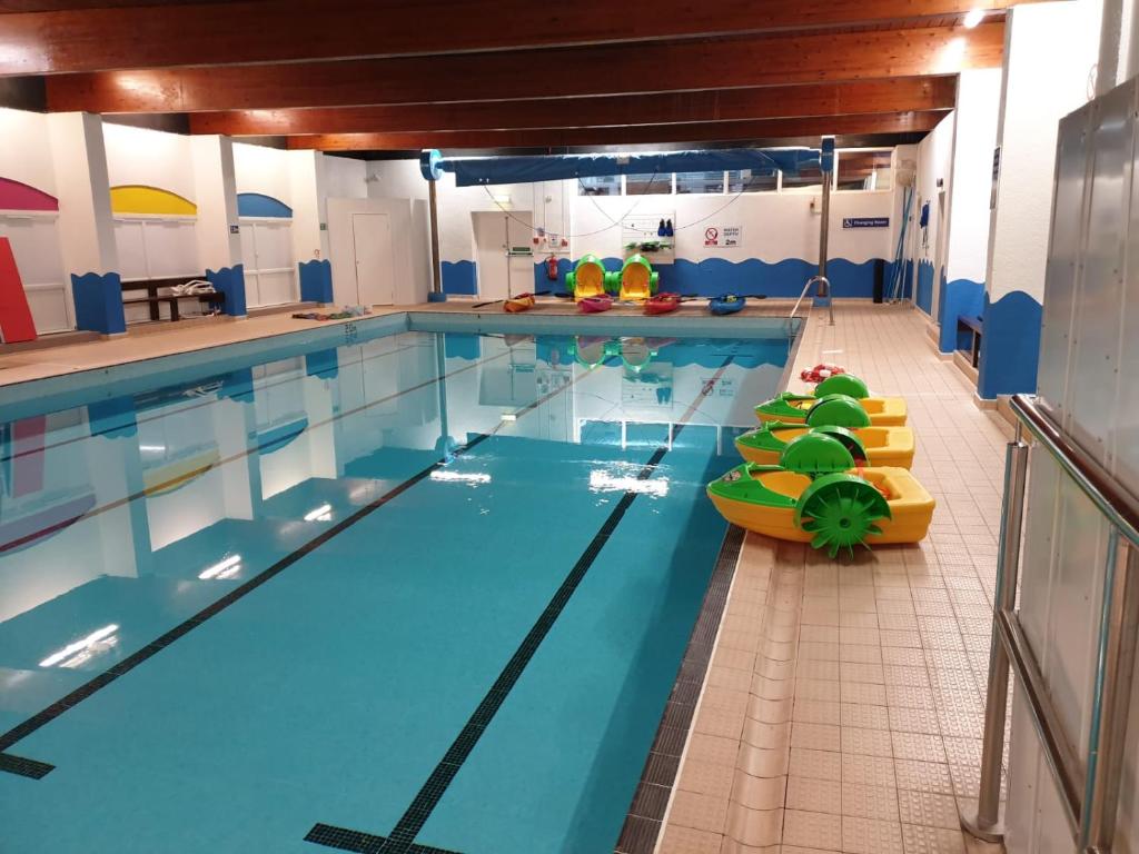 a large indoor swimming pool with a pool noodle at elbry in Heysham