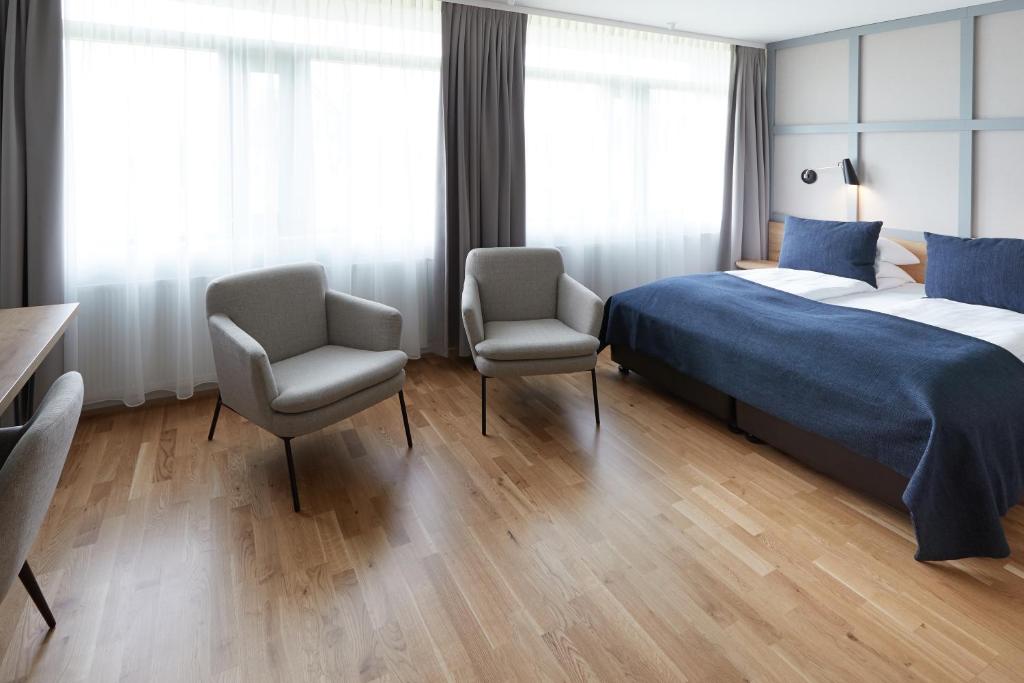 Postel nebo postele na pokoji v ubytování Fosshotel Reykholt