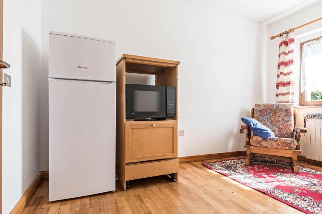 TV a/nebo společenská místnost v ubytování Baita Località Cap