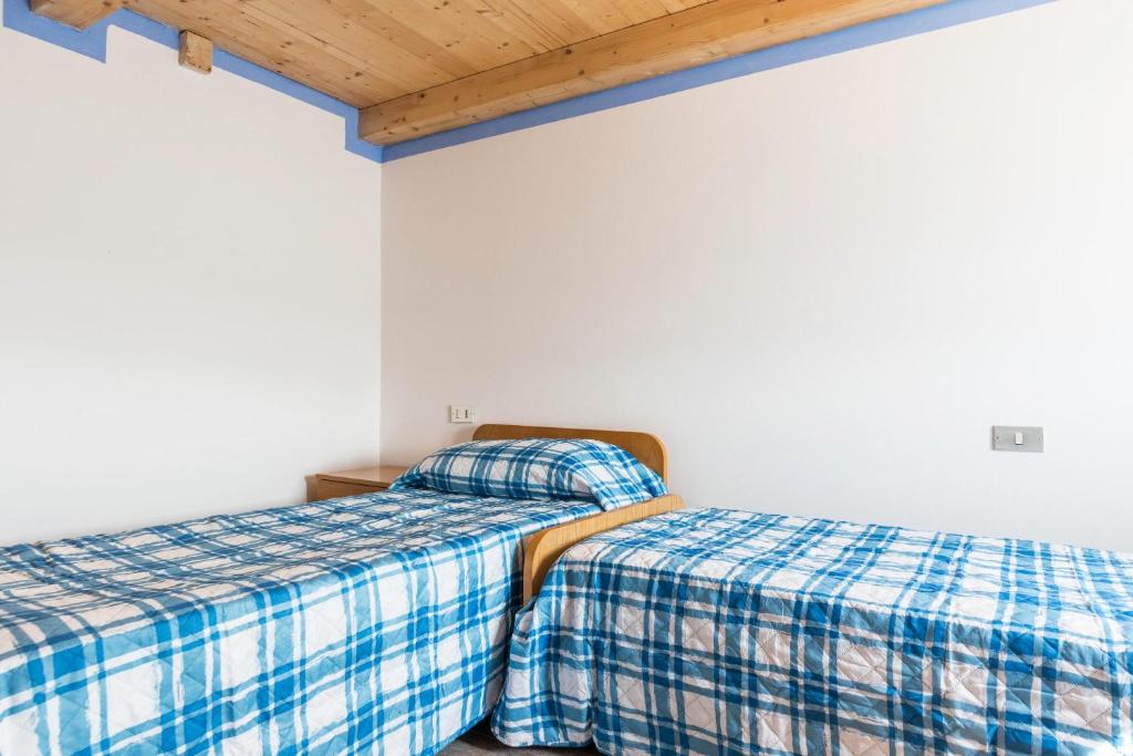 Postel nebo postele na pokoji v ubytování Baita Località Cap
