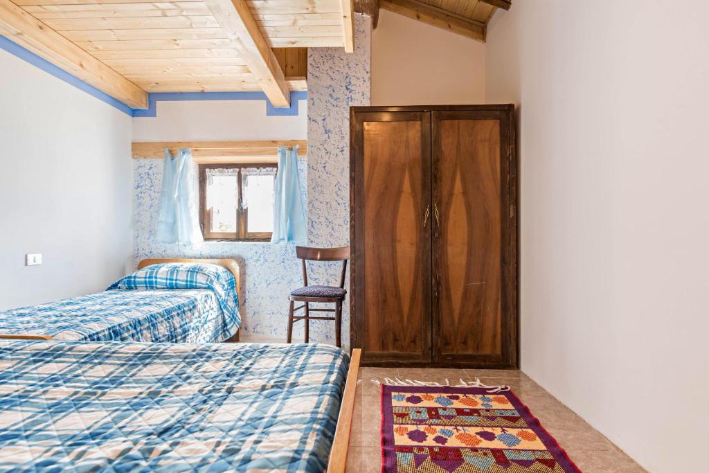 Postel nebo postele na pokoji v ubytování Baita Località Cap