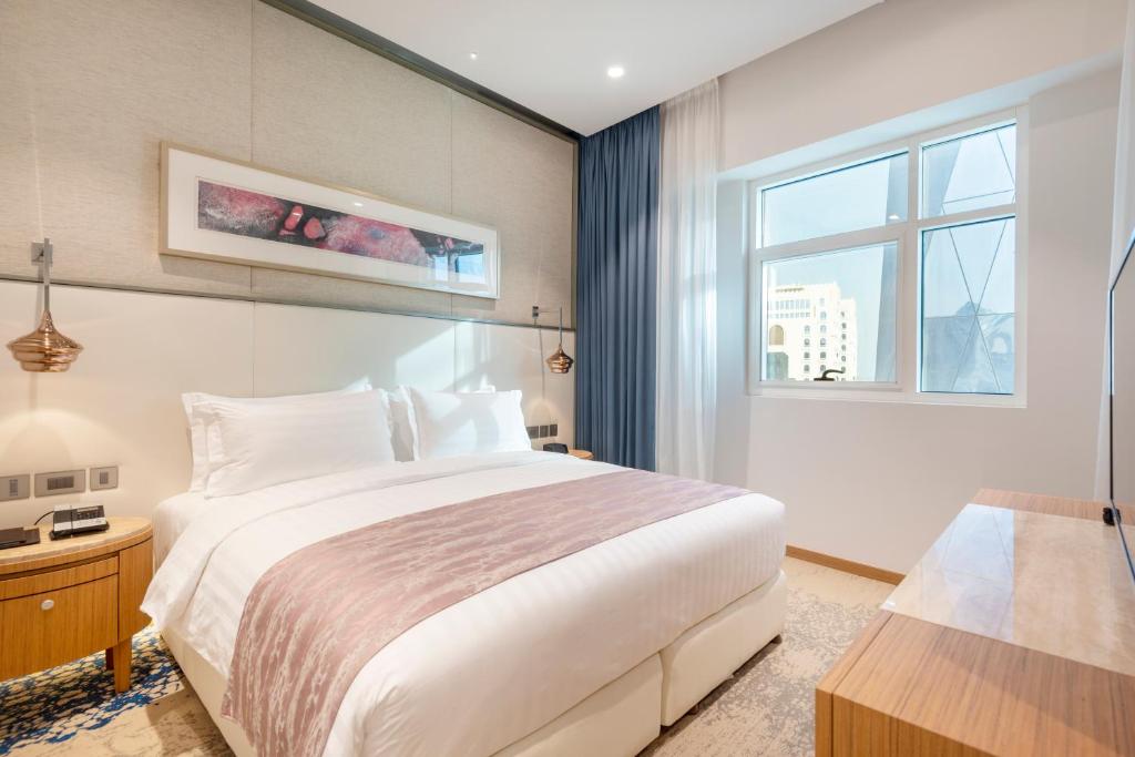 Postel nebo postele na pokoji v ubytování Jouri a Murwab hotel Doha
