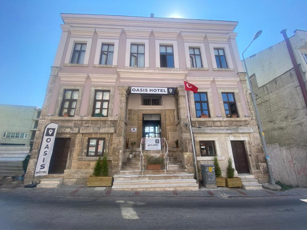 a large pink building on the corner of a street at Oasis Hotel Edirne in Edirne