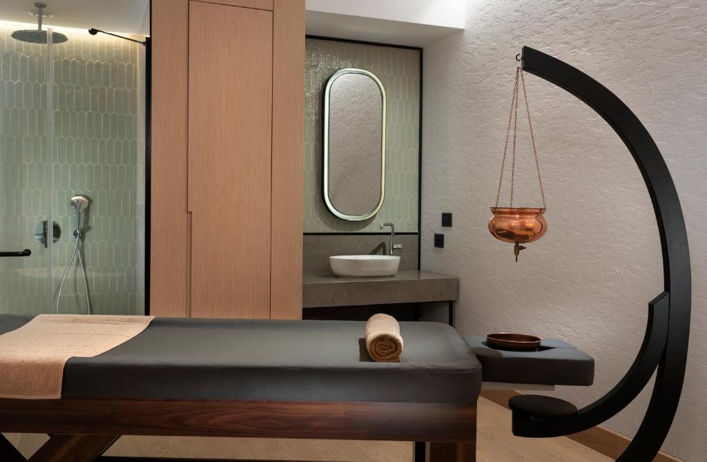 a bathroom with a shower and a sink at Radisson Collection Hotel, Bodrum in Akyarlar