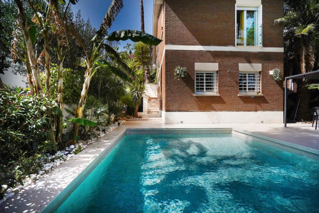 a swimming pool in front of a building at Luxury House with Pool in Castelldefels