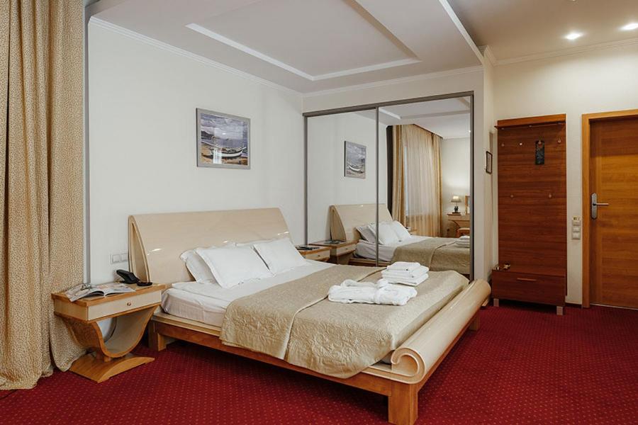 Postel nebo postele na pokoji v ubytování Residence Odesskij Dvorik