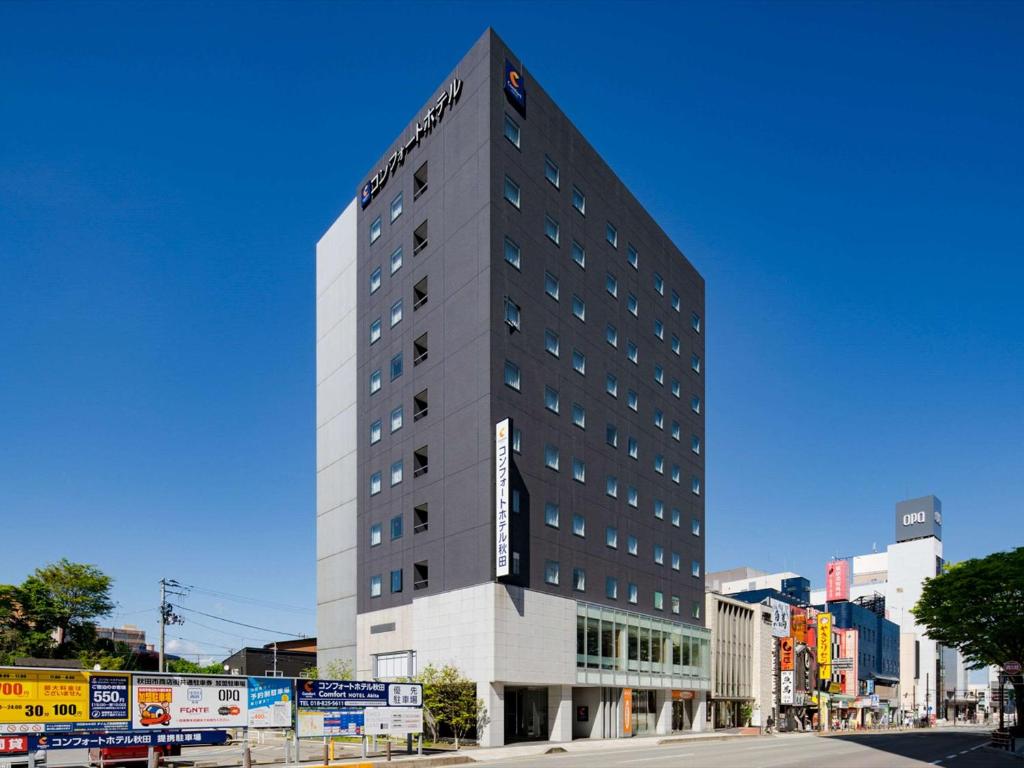 a tall building on the side of a street at Comfort Hotel Akita in Akita