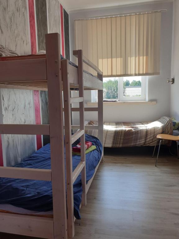 a bedroom with two bunk beds and a window at Türi Vibukooli majutus in Türi