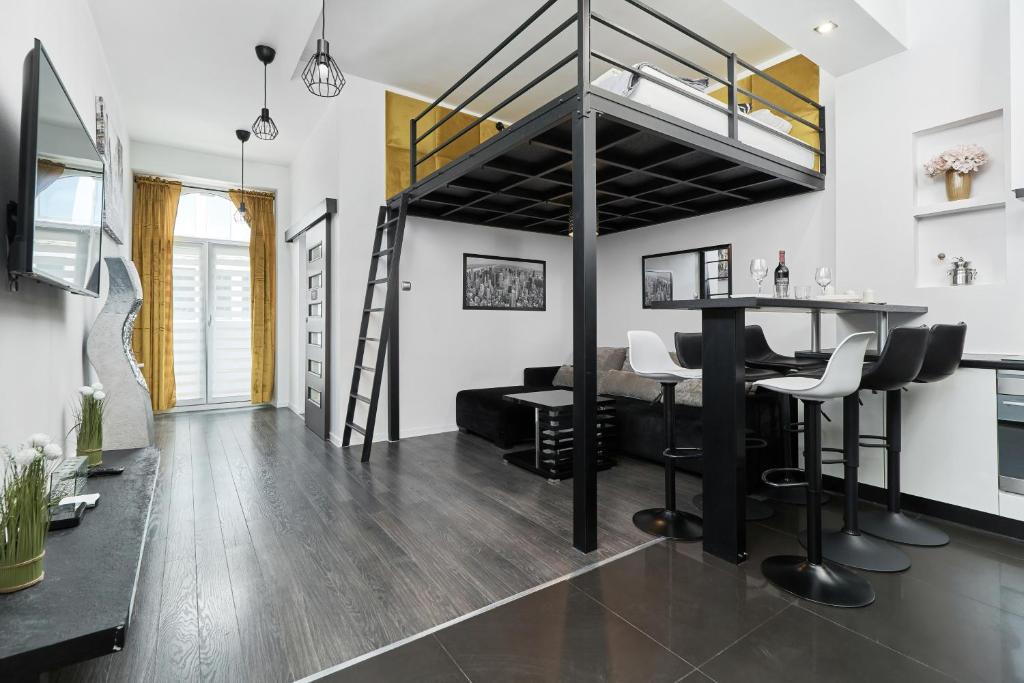 a living room with a loft bed and a bar at Apartments Wrocław Ruska by Renters in Wrocław
