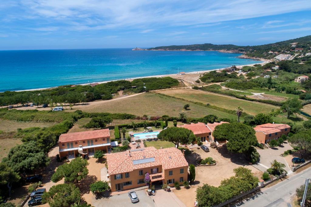an aerial view of a house and the ocean at Hôtel Les Lentisques in Cargèse