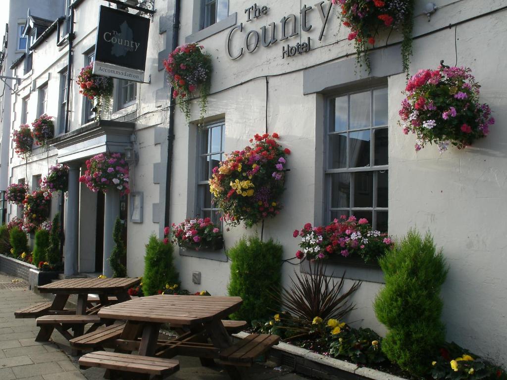 a group of picnic tables outside of a building at The County Hotel in Hexham