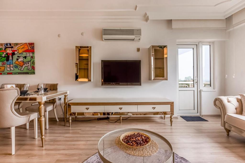 A television and/or entertainment centre at Melissas Suites Lara