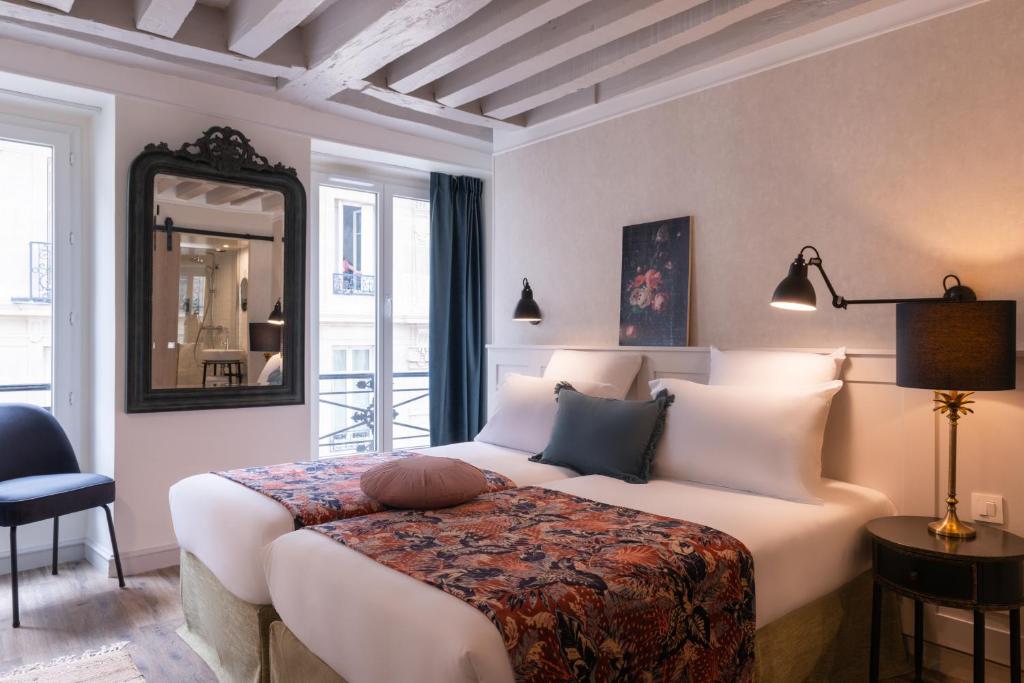 Ένα ή περισσότερα κρεβάτια σε δωμάτιο στο Hotel Touraine Opera