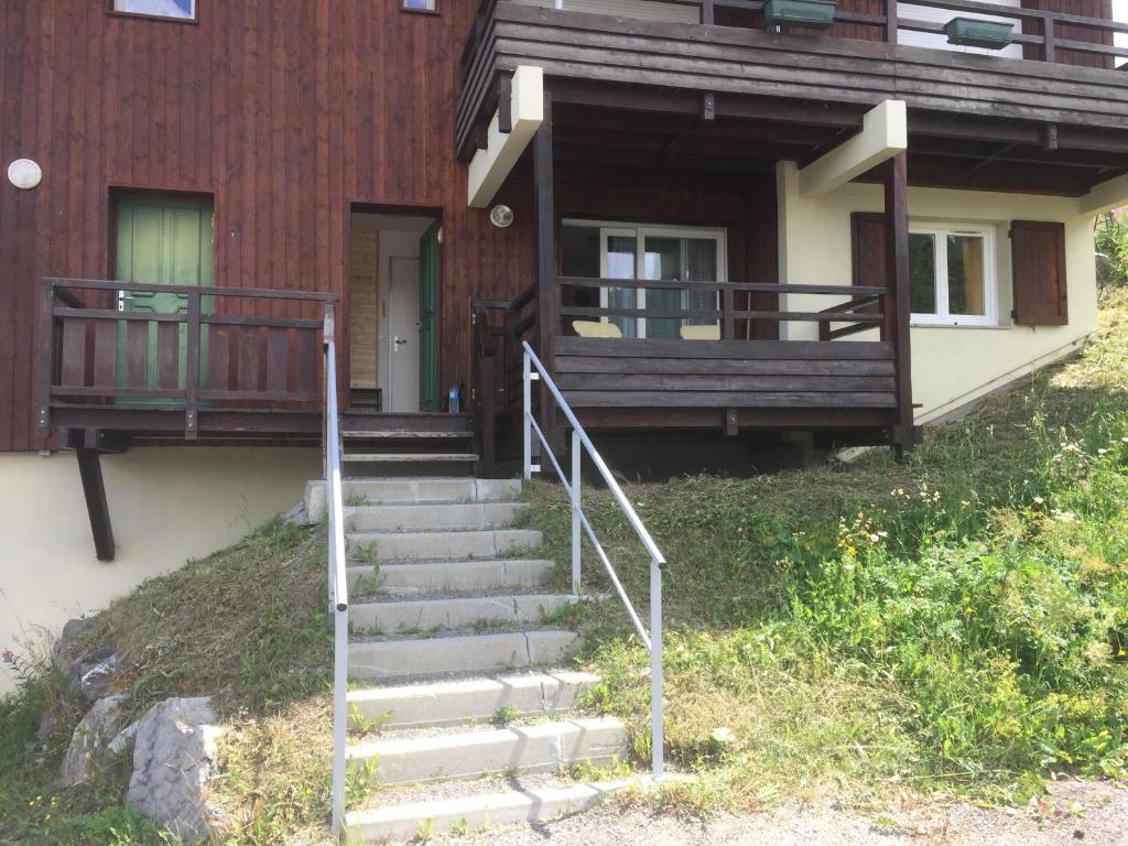 a staircase leading to a house with a porch at Chalet gentiane 1700 in Puy-Saint-Vincent